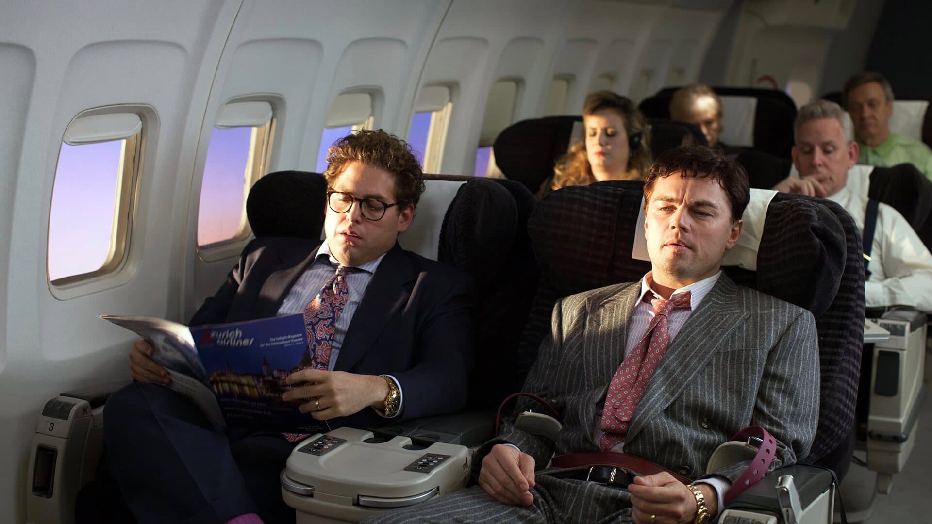 Jonah Hill as Donnie Azoff seated beside Jordan Belfort