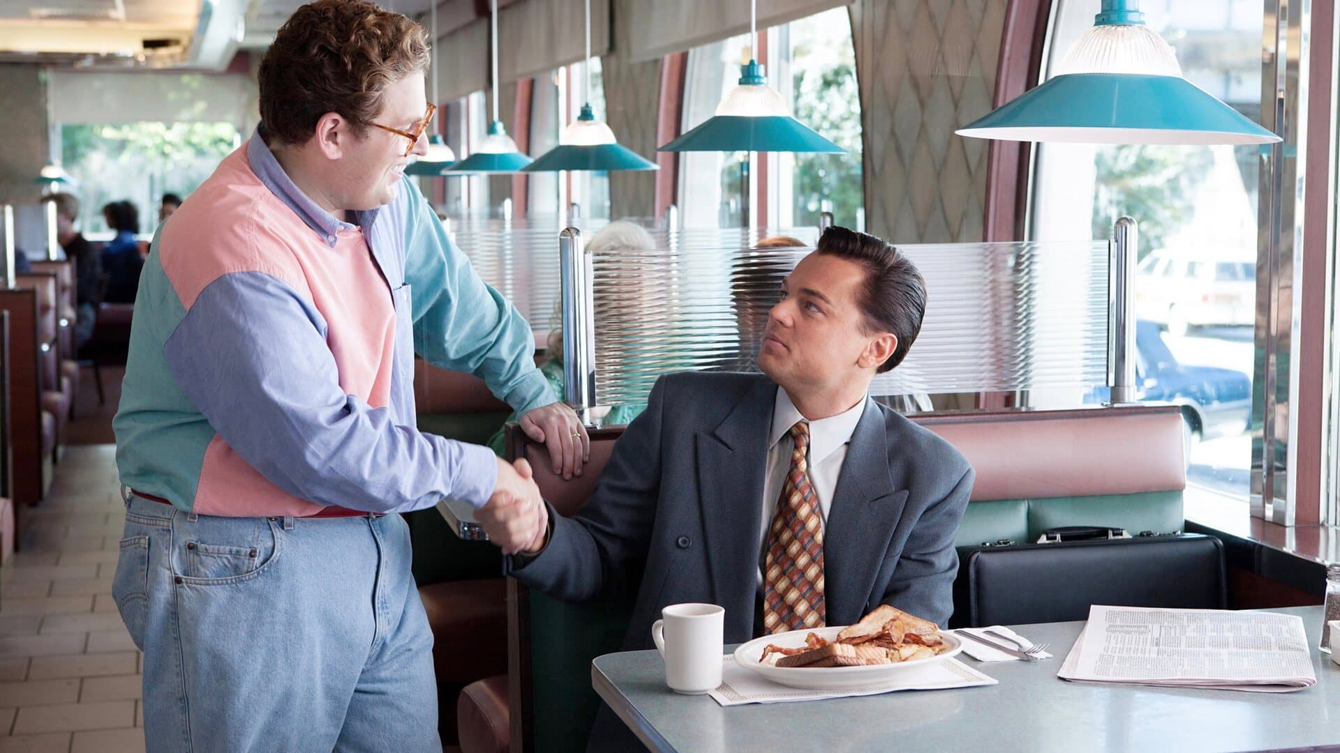 Leonardo DiCaprio as Jordan Belfort making his early pitch in The Wolf of Wall Street