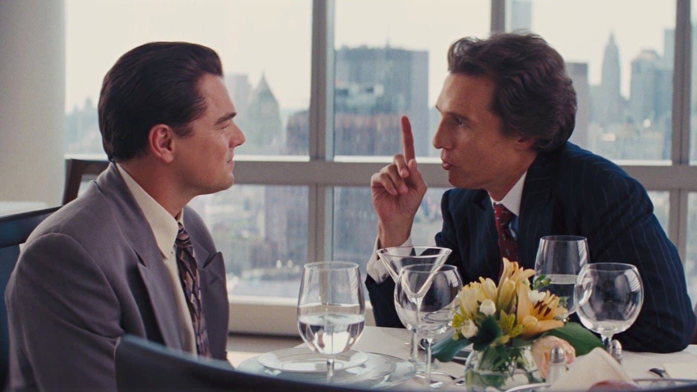 Matthew McConaughey as Mark Hanna at lunch with Jordan Belfort